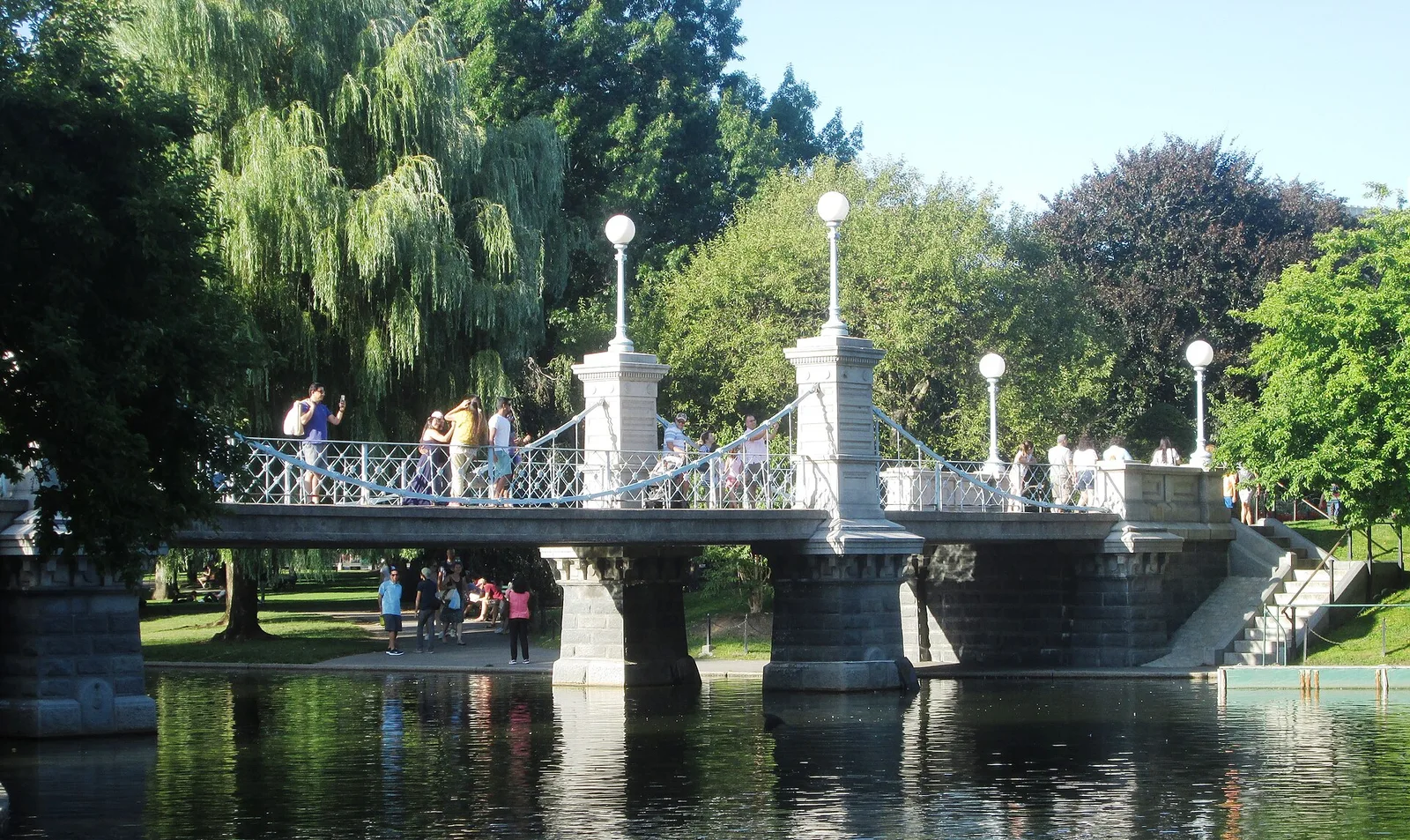 Summer greenery and the footbridge over the lagoon in Boston Public Garden