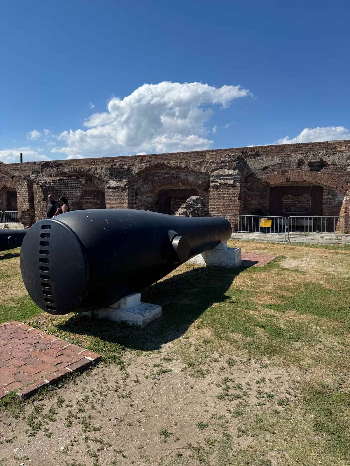 A Civil War cannon in front of the shell-damaged brick casemates at Fort Sumter in Charleston Harbor